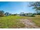 Spacious backyard with lush lawn, storage shed, and serene outdoor space at 91 Beverly Cir, Englewood, FL 34223