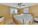 Inviting bedroom with a ceiling fan, vintage furniture, and natural light at 91 Beverly Cir, Englewood, FL 34223