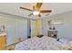 This cozy bedroom features neutral colored walls, a ceiling fan, and a closet for storage at 91 Beverly Cir, Englewood, FL 34223