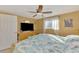 Bright bedroom with a ceiling fan, wooden furniture, and a relaxing atmosphere at 91 Beverly Cir, Englewood, FL 34223