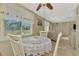 Bright eat in dining area featuring tile floors, a ceiling fan, a dining set and view of the outdoors at 91 Beverly Cir, Englewood, FL 34223