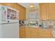 This lovely kitchen features wooden cabinets, a double basin sink, and stainless steel appliances at 91 Beverly Cir, Englewood, FL 34223