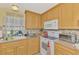 A functional kitchen with bright cabinetry, essential appliances, and a window view at 91 Beverly Cir, Englewood, FL 34223