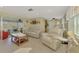 Open living room with tile floors and a view of an enclosed lanai at 91 Beverly Cir, Englewood, FL 34223