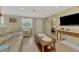 Inviting living room featuring tile floors and views into the bedroom at 91 Beverly Cir, Englewood, FL 34223
