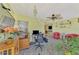 Bright sunroom with mosaic tile floors, ceiling fan, and desk perfect for a home office at 91 Beverly Cir, Englewood, FL 34223