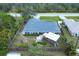 Aerial view of a fenced property featuring a fire pit, gazebo, and lush landscaping at 9341 Oceanspray Blvd, Englewood, FL 34224