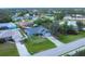 Aerial view of a home with lush landscaping, mature trees, and a long driveway at 9341 Oceanspray Blvd, Englewood, FL 34224