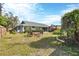 Expansive backyard with a patio, lush lawn, and mature landscaping, perfect for outdoor entertaining and relaxation at 9341 Oceanspray Blvd, Englewood, FL 34224