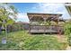 Spacious backyard featuring a wooden deck, green lawn, and a well-maintained fence, creating a private outdoor space at 9341 Oceanspray Blvd, Englewood, FL 34224