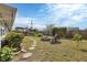 Lush backyard featuring a stone path, fire pit, and charming pergola, creating a serene outdoor oasis at 9341 Oceanspray Blvd, Englewood, FL 34224
