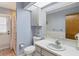Cozy bathroom featuring a white sink, toilet, and cabinet under a skylight, offering a bright and clean space at 9341 Oceanspray Blvd, Englewood, FL 34224