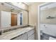 Bathroom with vanity, sink, mirror and view to the toilet at 9341 Oceanspray Blvd, Englewood, FL 34224