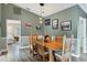 Dining room with wood table, wooden chairs, pendant lights, and neutral paint color at 9341 Oceanspray Blvd, Englewood, FL 34224