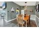 Dining room with table, seating for six, pendant lights, and view to the kitchen at 9341 Oceanspray Blvd, Englewood, FL 34224