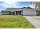 Charming single Gathering home featuring an attached garage and well-manicured lawn at 9341 Oceanspray Blvd, Englewood, FL 34224