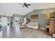 Inviting living room featuring wood floors, comfortable seating, and stylish decor at 9341 Oceanspray Blvd, Englewood, FL 34224