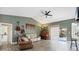 Spacious living room with vaulted ceilings, wood floors, and ample natural light at 9341 Oceanspray Blvd, Englewood, FL 34224
