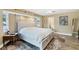 Bright main bedroom features wood floors, decor, and neutral paint color at 9341 Oceanspray Blvd, Englewood, FL 34224