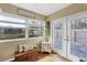 Sun room with wood floors, bright windows, and access to the backyard at 9341 Oceanspray Blvd, Englewood, FL 34224