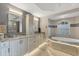 Bathroom featuring a tub, dual sinks, vanity, and walk-in shower at 9460 Migue Cir, Port Charlotte, FL 33981