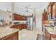 Spacious kitchen featuring granite countertops, stainless steel appliances, and custom wood cabinetry at 9460 Migue Cir, Port Charlotte, FL 33981