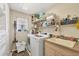 The laundry room features a utility sink, washer, dryer, and ample storage at 9460 Migue Cir, Port Charlotte, FL 33981