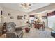 The living room is illuminated by a ceiling fan and features large windows at 9460 Migue Cir, Port Charlotte, FL 33981