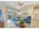 Spacious living room with vaulted ceilings, tile floors, and sliding glass doors to the patio at 9460 Migue Cir, Port Charlotte, FL 33981