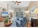 Open-concept living area featuring tile floors, stylish furnishings, and an adjacent dining area at 9460 Migue Cir, Port Charlotte, FL 33981