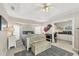 This bright main bedroom boasts a tray ceiling, ensuite office, and stylish decor at 9460 Migue Cir, Port Charlotte, FL 33981