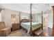 Bedroom with wood floors, tray ceiling and ensuite bathroom at 9460 Migue Cir, Port Charlotte, FL 33981