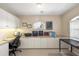 A well-lit office space features built-in cabinets and a view from a arched window at 9460 Migue Cir, Port Charlotte, FL 33981