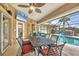 This screened patio is equipped with a ceiling fan and an outdoor television at 9460 Migue Cir, Port Charlotte, FL 33981