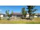 Spacious backyard with a screened-in lanai, mature landscaping, and chain link fence at 95 Mark Twain Ln, Rotonda West, FL 33947