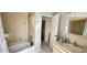 Standard tiled bathroom features a shower-tub combination and vanity at 95 Mark Twain Ln, Rotonda West, FL 33947