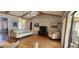 Bright living room featuring vaulted ceilings with exposed beams, hardwood floors, and comfortable seating at 95 Mark Twain Ln, Rotonda West, FL 33947