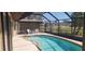 Enclosed pool with clear blue water offering privacy and comfort at 95 Mark Twain Ln, Rotonda West, FL 33947