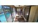 Sunroom features a lovely view of the pool, tile flooring, and sliding doors at 95 Mark Twain Ln, Rotonda West, FL 33947