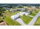Aerial view of a home with a pool, large yard, and detached garage, offering a suburban lifestyle at 10075 Bentley Ave, Englewood, FL 34224