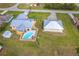 Aerial view featuring a home with a pool and an adjacent detached garage, highlighting the property's layout at 10075 Bentley Ave, Englewood, FL 34224
