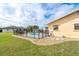 Fenced backyard featuring an inviting pool area and meticulously manicured landscaping, offering a serene outdoor experience at 10075 Bentley Ave, Englewood, FL 34224