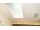 Bright bathroom featuring skylight and tile detailing at 10075 Bentley Ave, Englewood, FL 34224