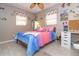 Bedroom with rainbow comforter at 10075 Bentley Ave, Englewood, FL 34224