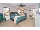 Cozy bedroom featuring a ceiling fan, carpeted floors, a large bed, and mirrored closet doors at 10075 Bentley Ave, Englewood, FL 34224