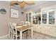 Inviting dining area featuring built in hutch, farmhouse table, and ceiling fan at 10075 Bentley Ave, Englewood, FL 34224