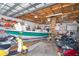 Spacious garage with boat storage, workbench, and multiple motorcycles, providing ample space for hobbies at 10075 Bentley Ave, Englewood, FL 34224