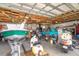 Spacious garage storing a boat, classic car, motorcycles, and scooters, offering ample storage and enthusiast space at 10075 Bentley Ave, Englewood, FL 34224