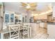 Open kitchen and dining area with a ceiling fan, and breakfast bar at 10075 Bentley Ave, Englewood, FL 34224