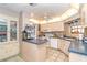 Bright kitchen area with tiled floor, blue countertops, white appliances, and window at 10075 Bentley Ave, Englewood, FL 34224